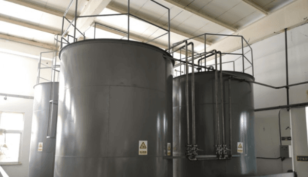 Stainless steel storage tanks inside the production facility